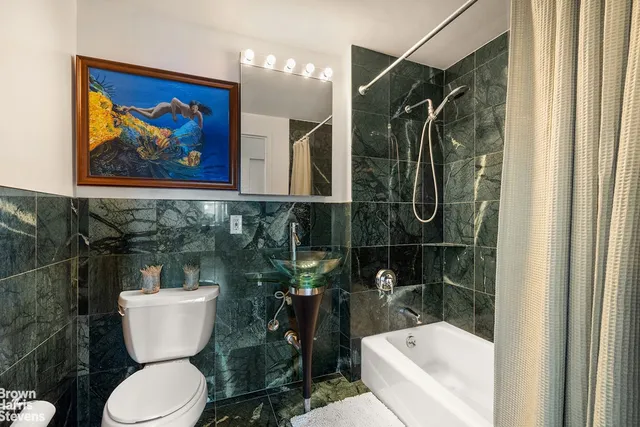 a bedroom with a bed and a potted plant