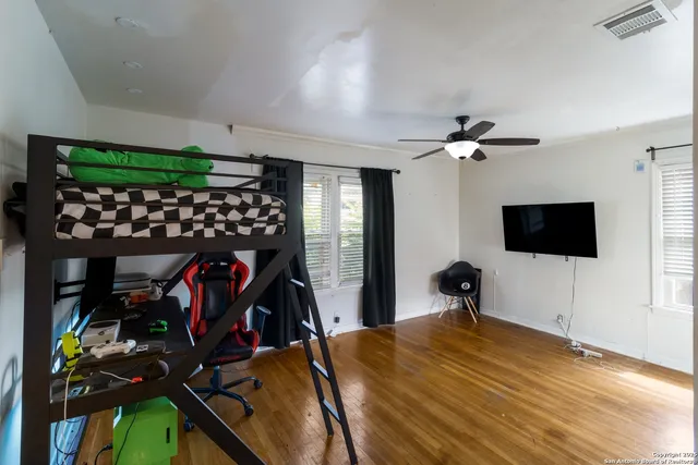 a bedroom with a bed and a flat screen tv