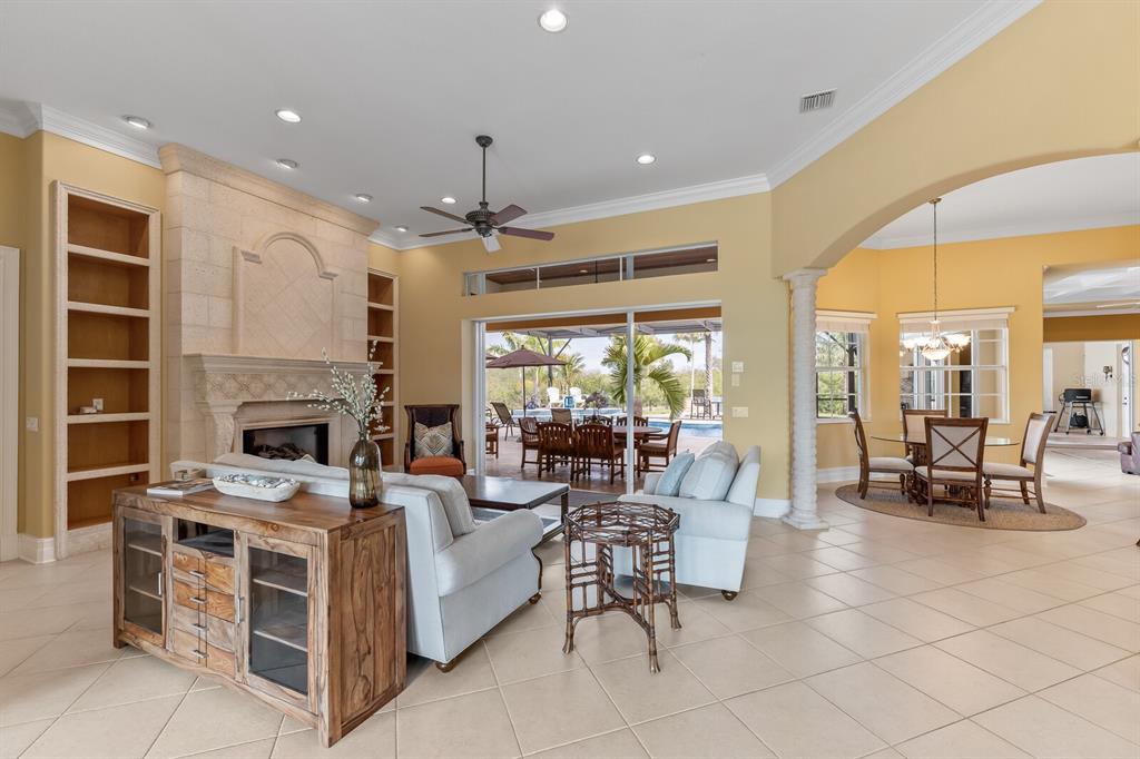 3700 Como Street Port Charlotte, FL 33948 - Photo 12 of 88 a living room with furniture a fireplace and a dining table with a large window