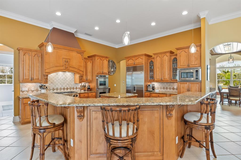 3700 Como Street Port Charlotte, FL 33948 - Photo 20 of 88 a kitchen with stainless steel appliances granite countertop a stove a sink and a dining table