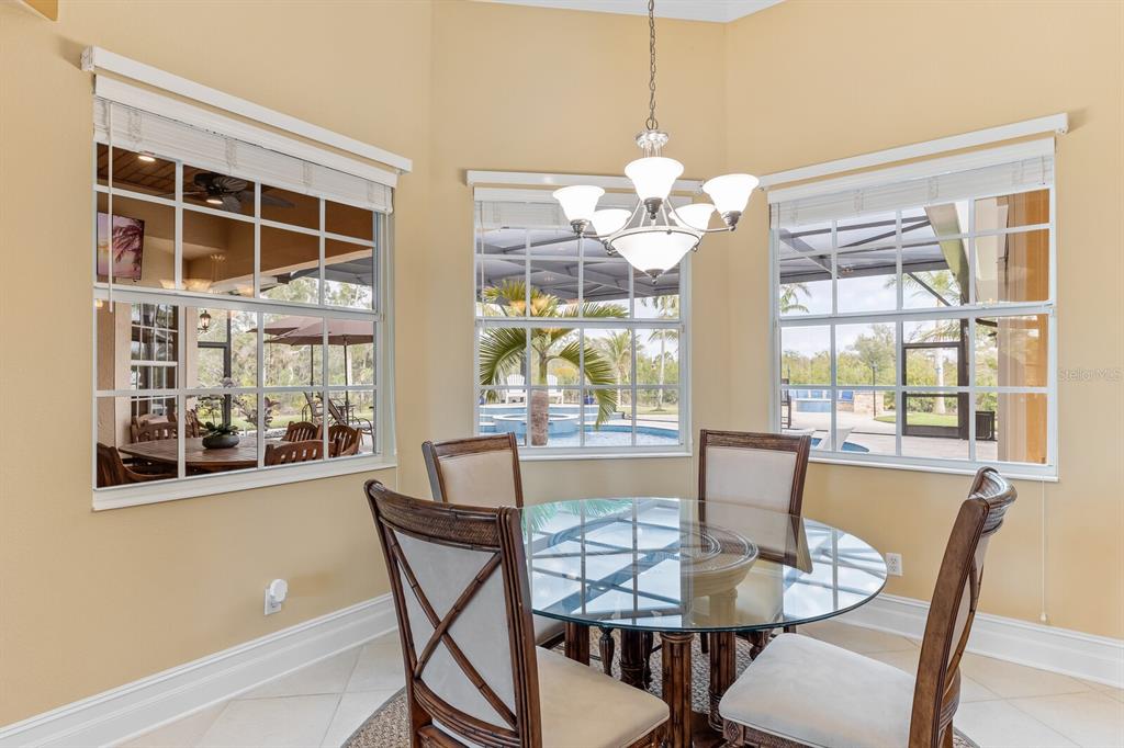 3700 Como Street Port Charlotte, FL 33948 - Photo 22 of 88 a view of a dining room with furniture large windows and wooden floor
