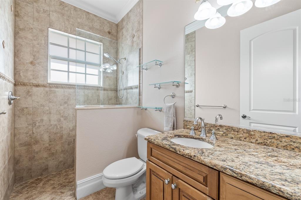 3700 Como Street Port Charlotte, FL 33948 - Photo 45 of 88 a bathroom with a granite countertop toilet a sink and a mirror