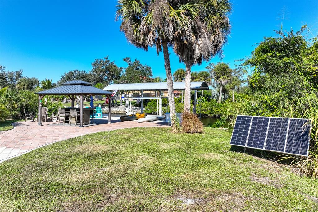 3700 Como Street Port Charlotte, FL 33948 - Photo 49 of 88 a view of a swimming pool with lawn chairs under an umbrella