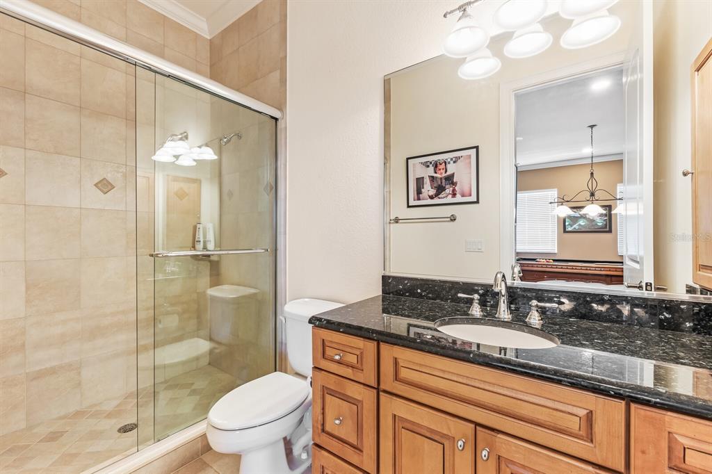 3700 Como Street Port Charlotte, FL 33948 - Photo 65 of 88 a bathroom with a granite countertop sink toilet a mirror and shower