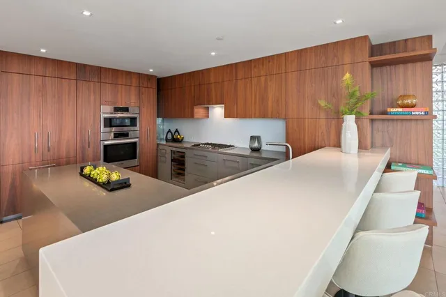 a kitchen with a refrigerator and a stove top oven