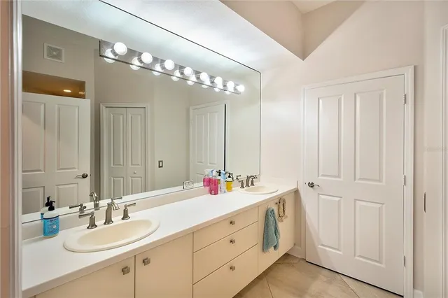 a bathroom with a double vanity sink mirror and