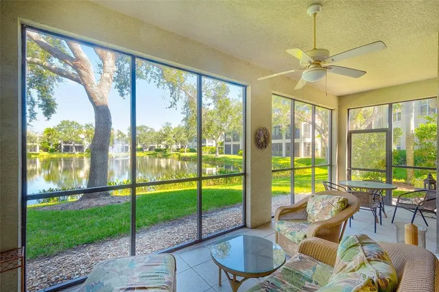 a living room with a floor to ceiling windows and pool table