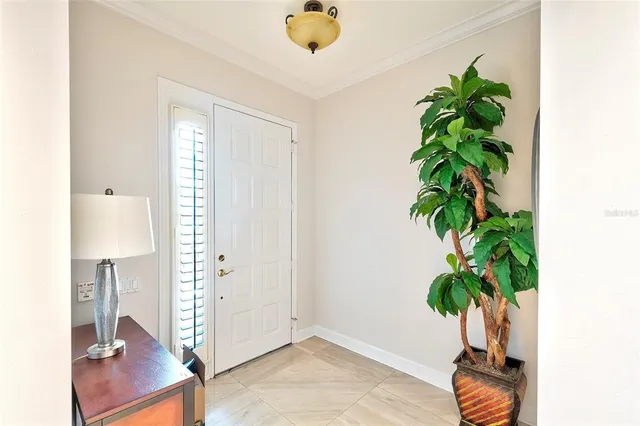 a view of entryway with livingroom and potted plant