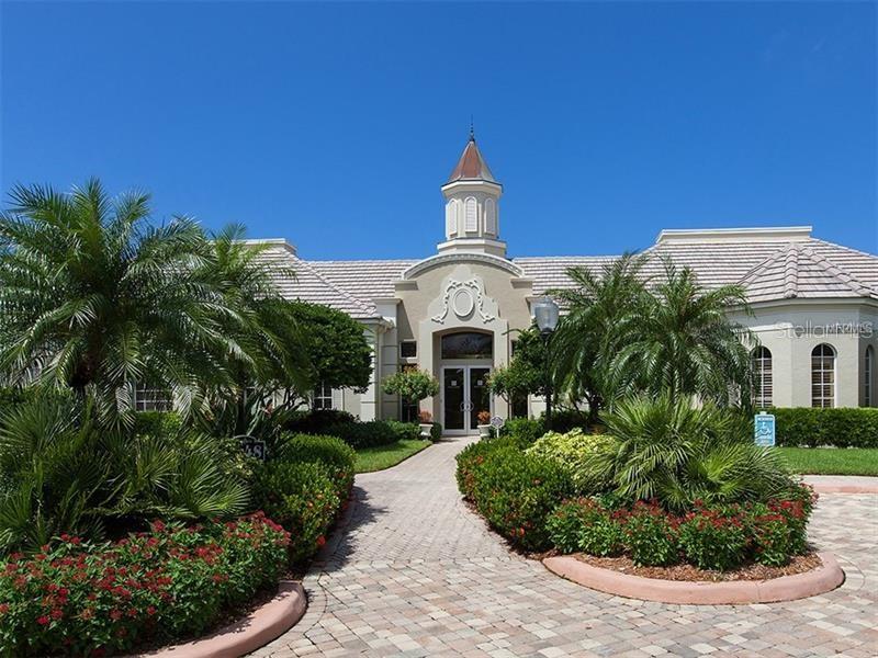 5264 Bouchard Circle, Unit 102 Sarasota, FL 34238 - Photo 26 of 32 a front view of a house with a yard