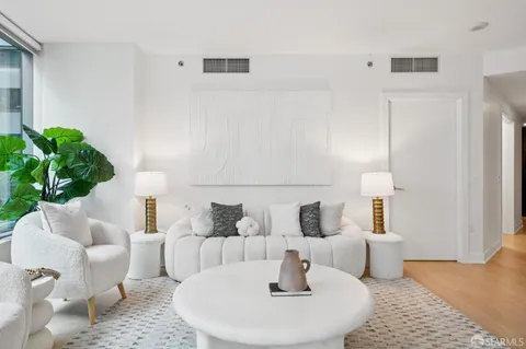 a living room with furniture and a potted plant