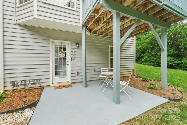 a view of roof deck with chair and table
