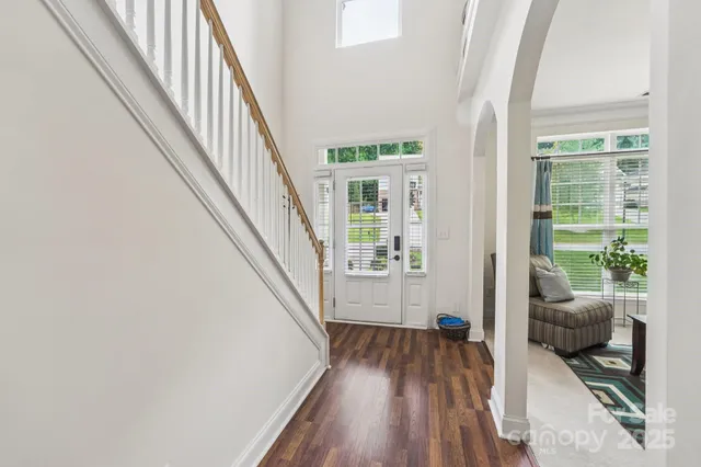 a view of a livingroom with wooden floor and stairs