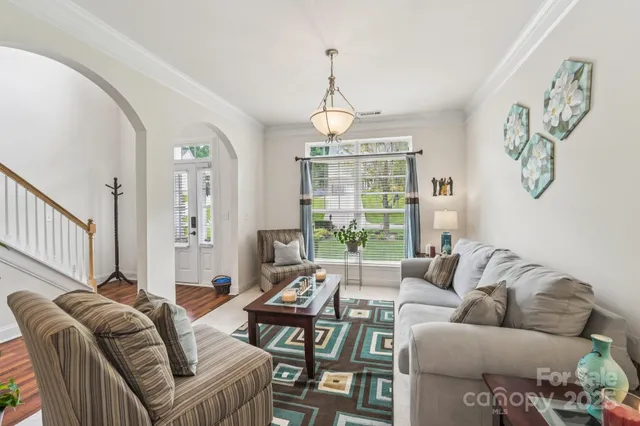 a living room with furniture ceiling fan and a rug