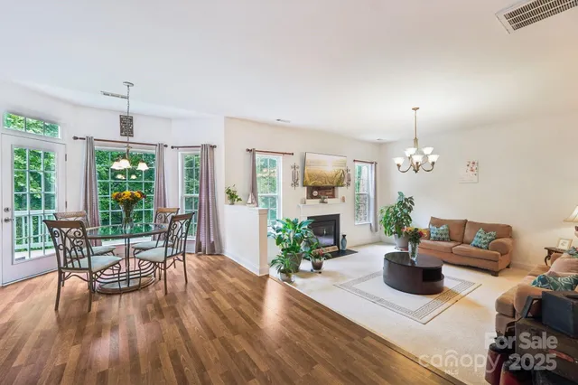 a living room with furniture fireplace and potted plants