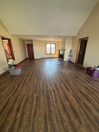 a view of a room with wooden floor and staircase