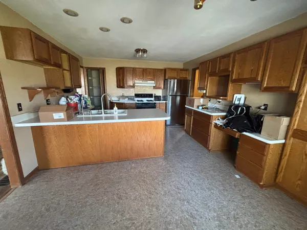 a view of kitchen with sink microwave and cabinets