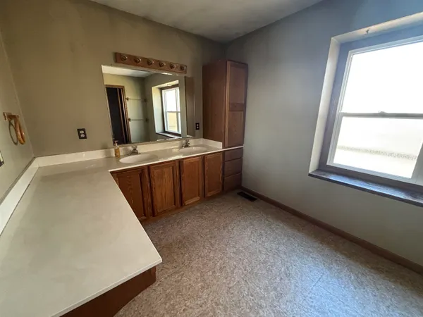 a view of hallway with window and stairs