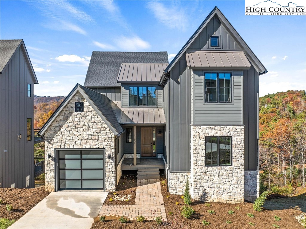 359 Calico Court Boone, NC 28607 - Photo 1 of 48 a front view of a house with a garden