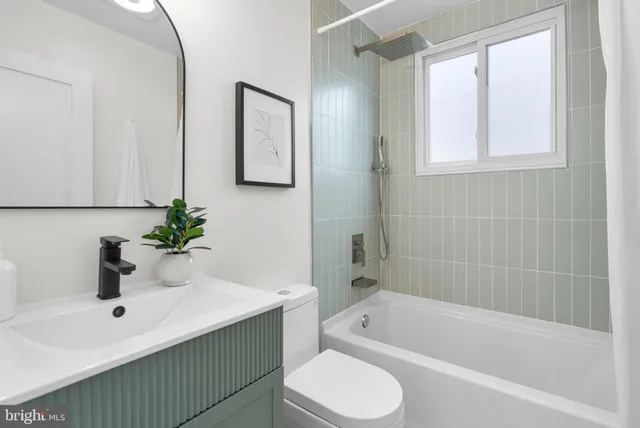 a bathroom with a sink a toilet and bathtub