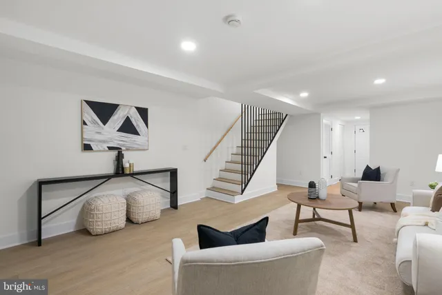 a living room with furniture and a painting on the wall