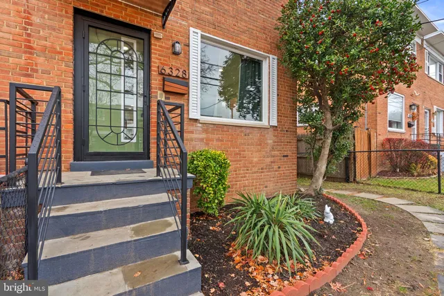 a view of a house with a window and wooden fence
