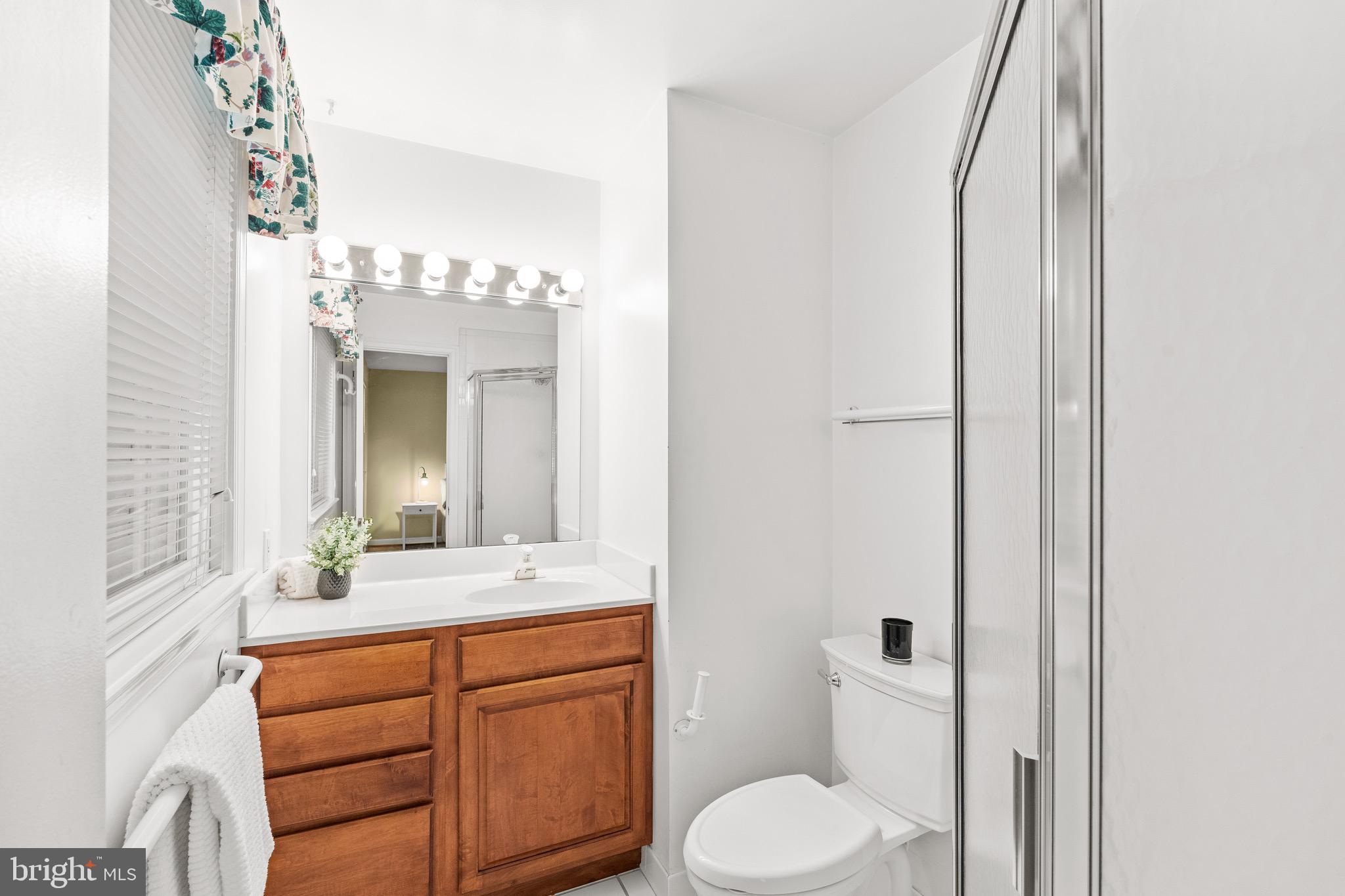 6604 Grey Fox Drive Springfield, VA 22152 - Photo 21 of 46 a bathroom with a granite countertop sink vanity mirror and toilet