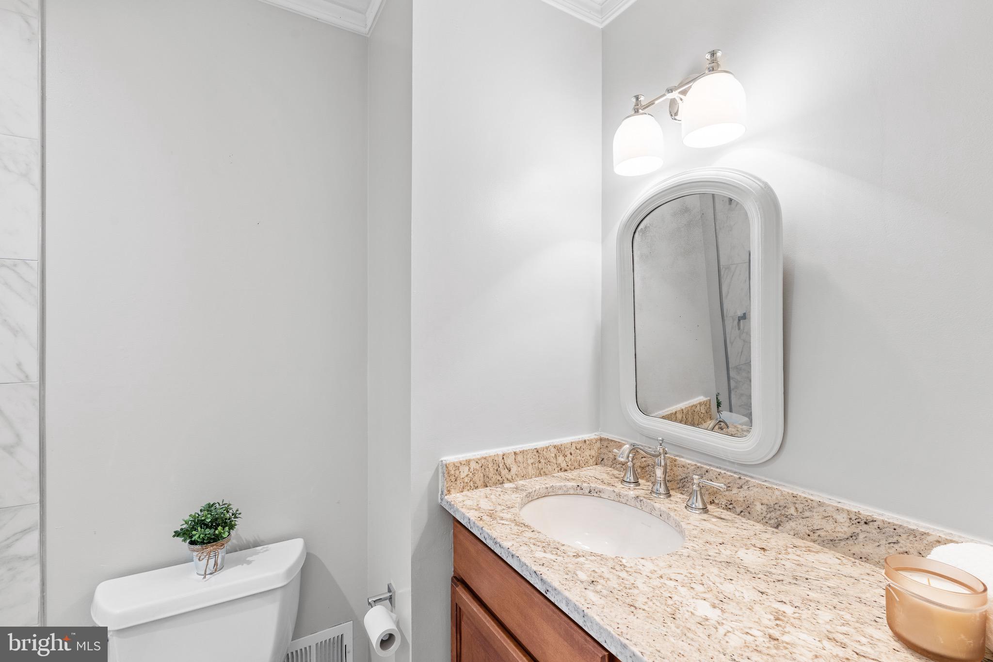 6604 Grey Fox Drive Springfield, VA 22152 - Photo 27 of 46 a bathroom with a granite countertop sink and a mirror