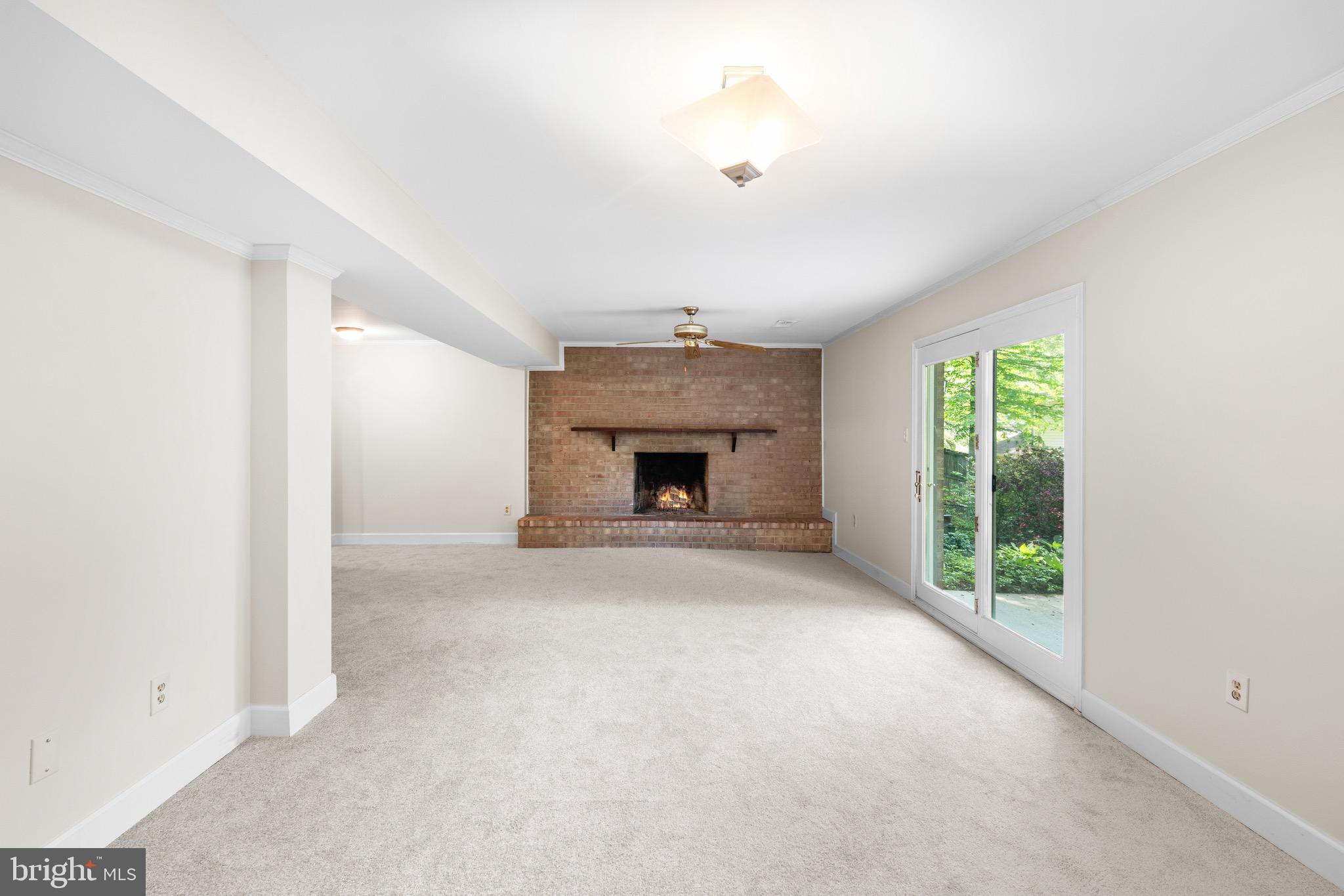 6604 Grey Fox Drive Springfield, VA 22152 - Photo 31 of 46 an empty room with windows and a fireplace