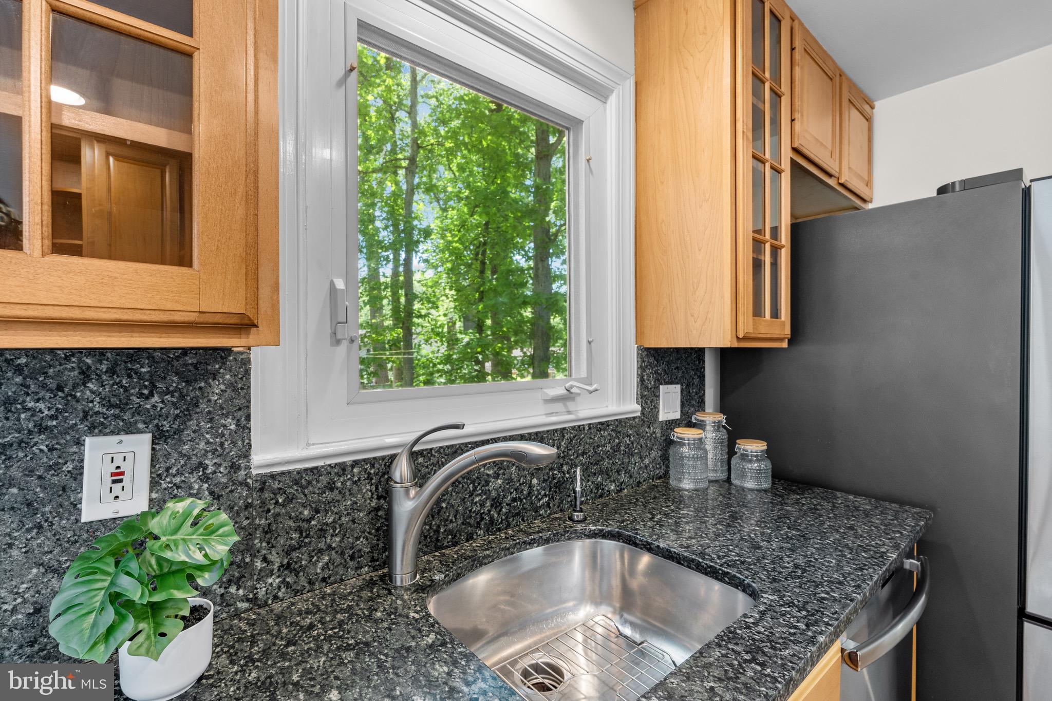 6604 Grey Fox Drive Springfield, VA 22152 - Photo 9 of 46 a kitchen with a sink a window and cabinets