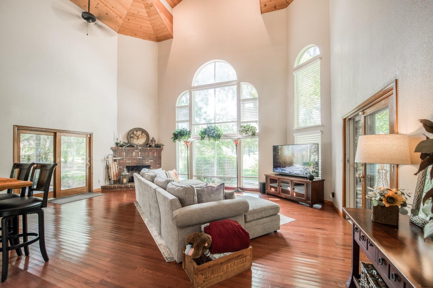 19408 Farallon Road Madera, CA 93638 - Photo 13 of 62 a living room with furniture fireplace and a large window