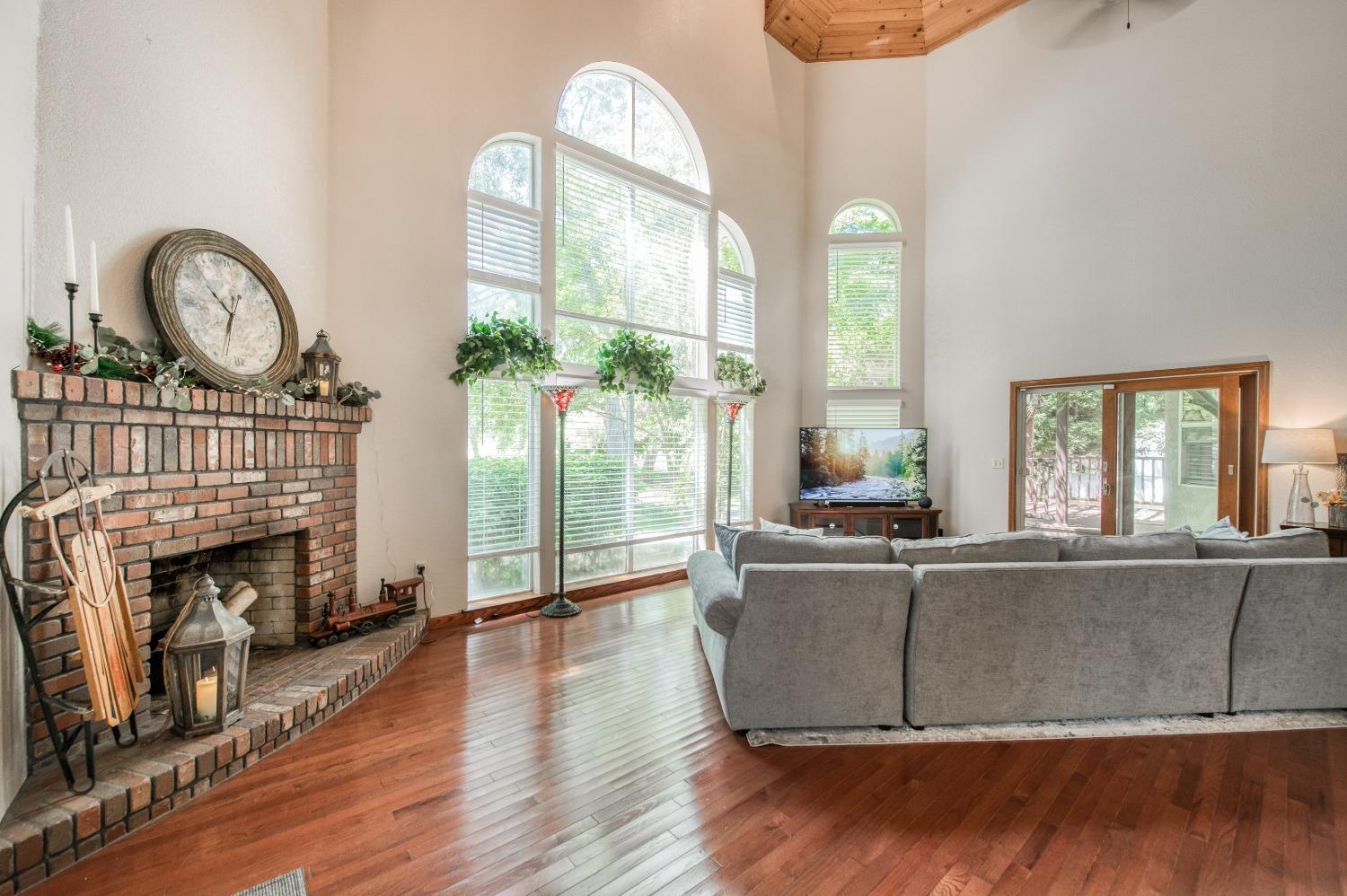 19408 Farallon Road Madera, CA 93638 - Photo 16 of 62 a living room with furniture a fireplace and a large window