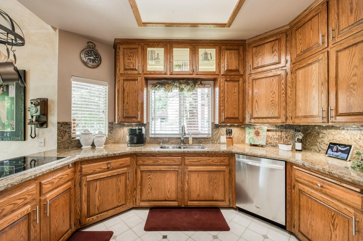 19408 Farallon Road Madera, CA 93638 - Photo 23 of 62 a kitchen with stainless steel appliances a sink stove and cabinets