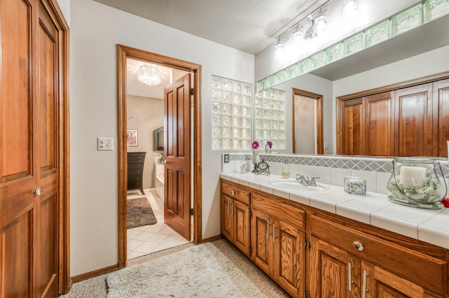 19408 Farallon Road Madera, CA 93638 - Photo 42 of 62 a bathroom with a double vanity sink mirror and shower