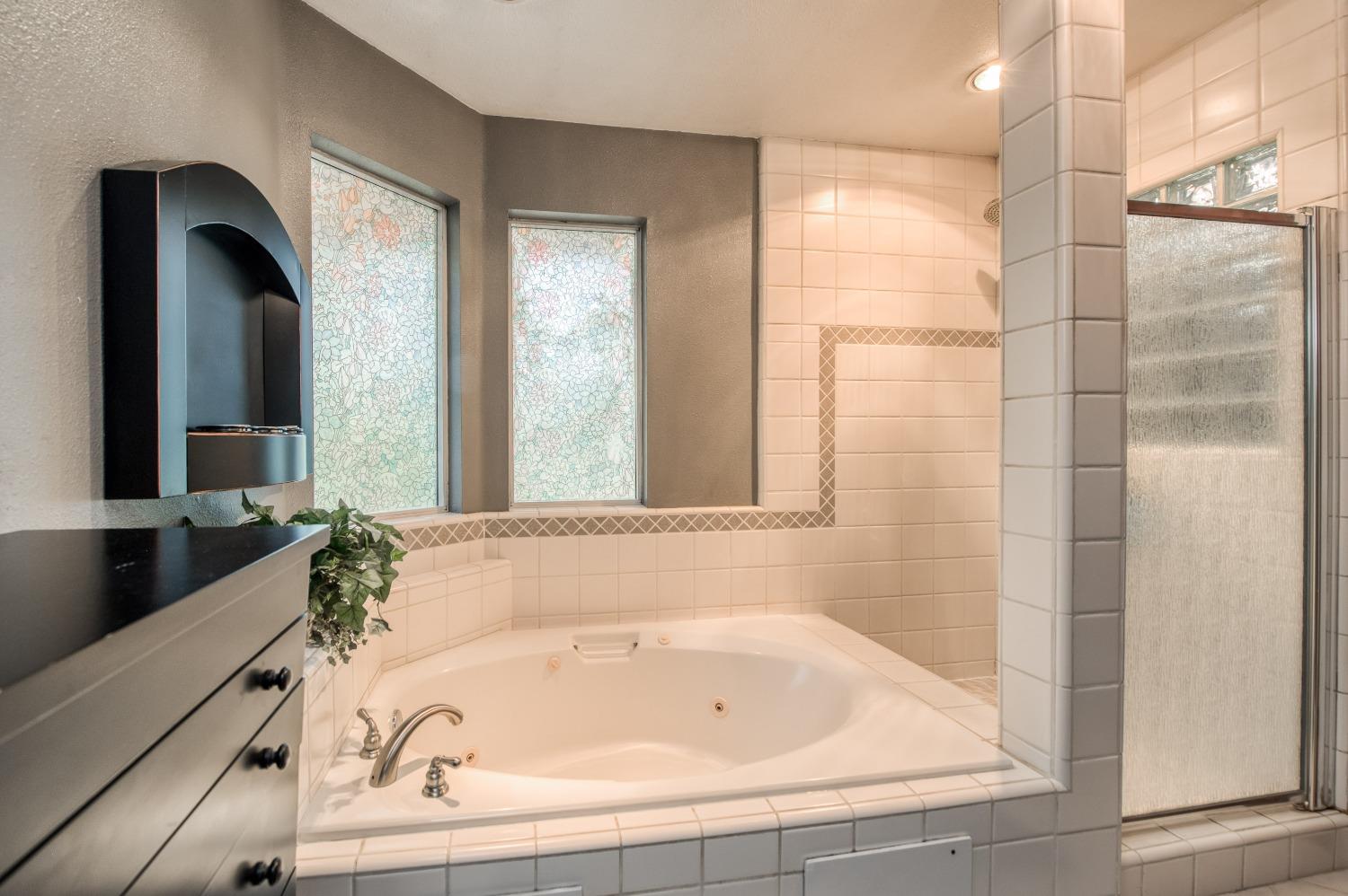 19408 Farallon Road Madera, CA 93638 - Photo 43 of 62 a bathroom with a bathtub and a shower
