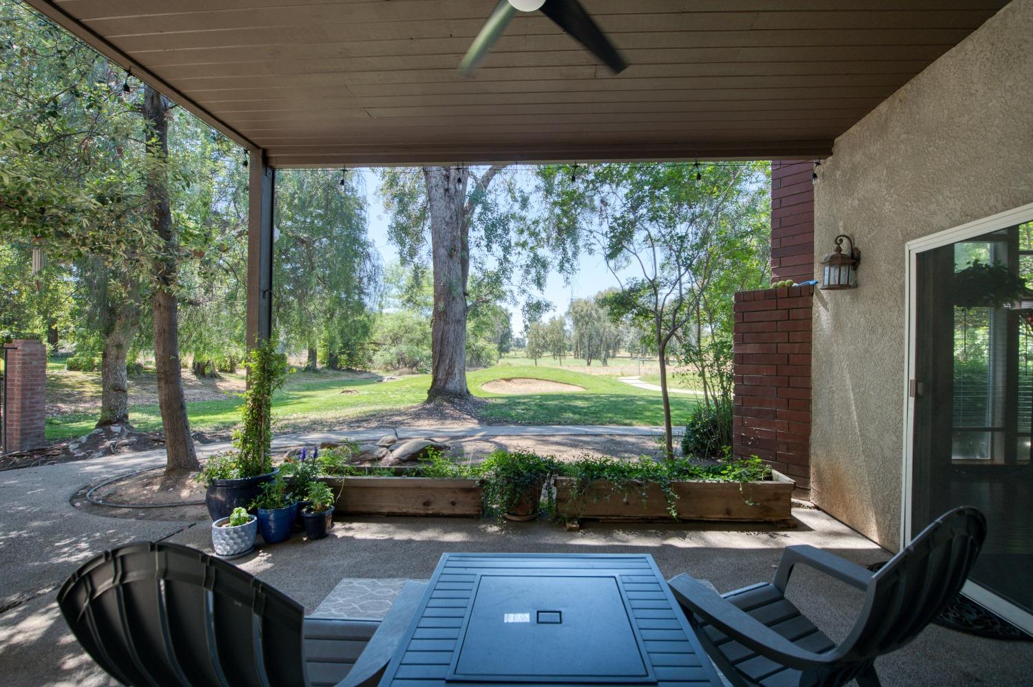 19408 Farallon Road Madera, CA 93638 - Photo 53 of 62 a view of a patio with table and chairs potted plants and floor to ceiling window