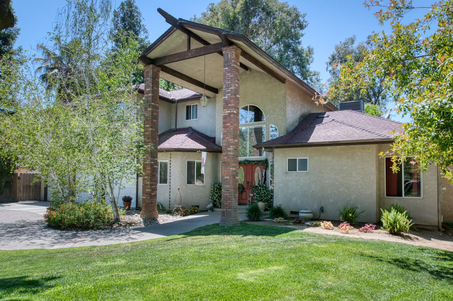 19408 Farallon Road Madera, CA 93638 - Photo 7 of 62 a view of a house with a yard and plants
