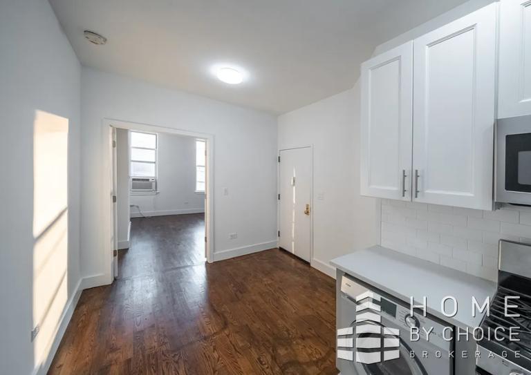 a view of a kitchen with wooden floor and a sink