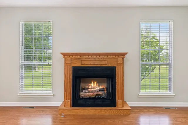 a living room with a fireplace and a window