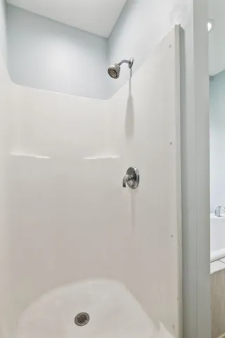 a bathroom with a granite countertop sink mirror and cabinets