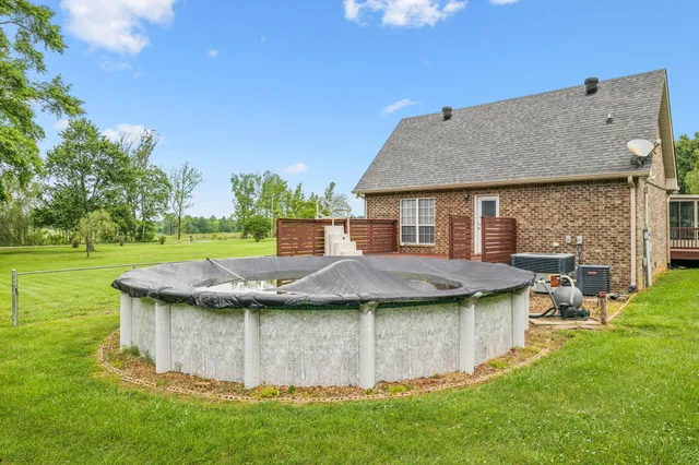 a backyard of a house with trampoline