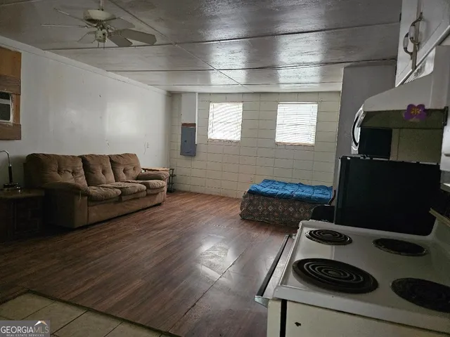 a living room with furniture and a flat screen tv