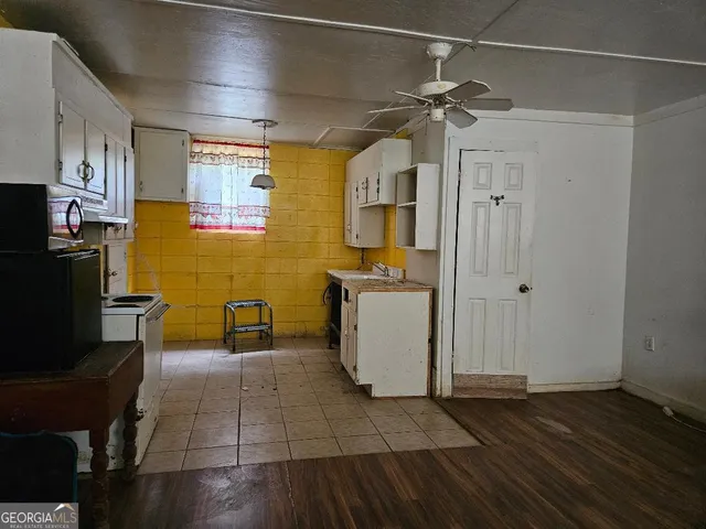 a kitchen with stainless steel appliances a refrigerator and a stove top oven