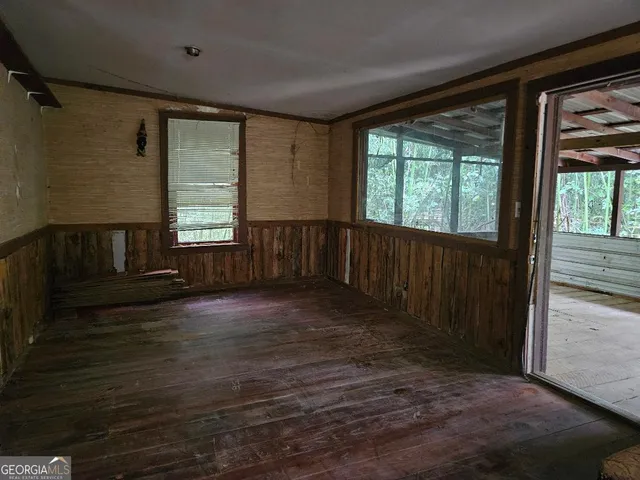 wooden floor in an empty room with a window