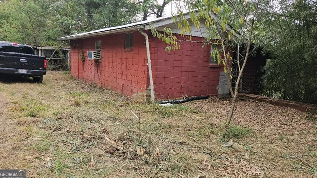 a view of backyard and wooden fence