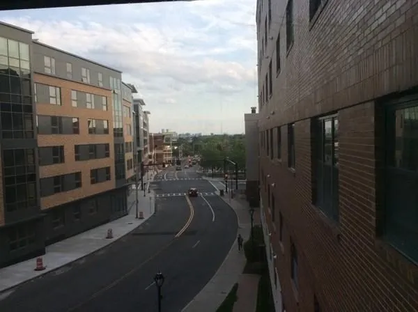 a kitchen with stainless steel appliances a refrigerator a sink a stove a microwave and wooden cabinets