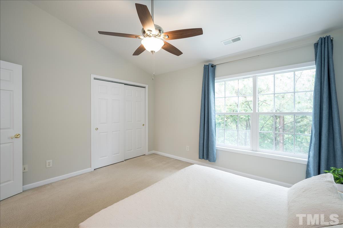 5414 Echo Ridge Road Raleigh, NC 27612 - Photo 12 of 22 a bedroom with a large bed and a large window