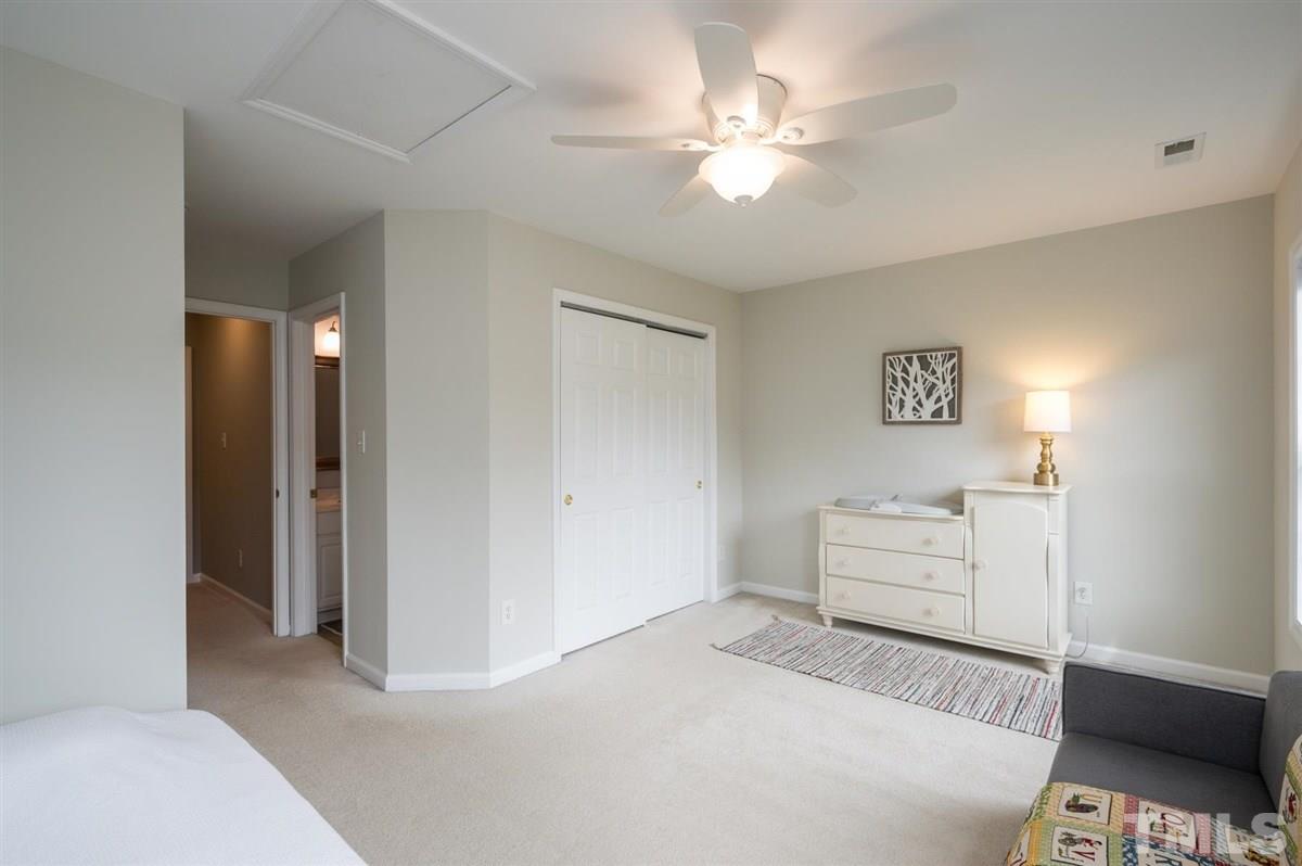5414 Echo Ridge Road Raleigh, NC 27612 - Photo 15 of 22 a room with a bed and a chandelier