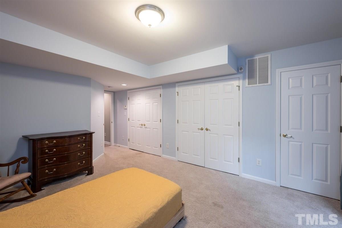 5414 Echo Ridge Road Raleigh, NC 27612 - Photo 18 of 22 a spacious bedroom with a bed and a dresser