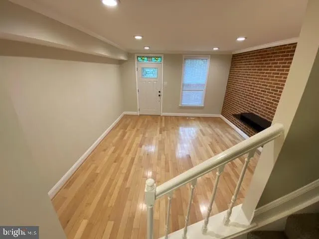 a view of an empty room with wooden floor