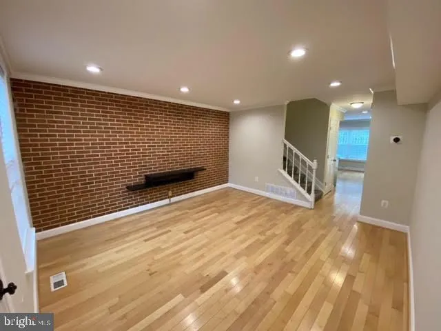 a view of a hall with wooden floor